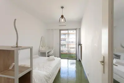 a white room with a bed and a window at L28 Suite Californie 1min walk sea 3BDR/ AC & balcony in Nice