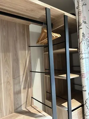 a closet with wooden shelving in a room at Studio HYPER CENTRE in Nice