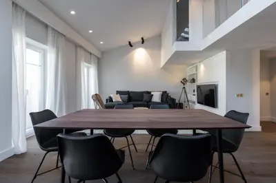 a dining room with a large wooden table and chairs at Duplex Nice Avenue Jean-Médecin in Nice