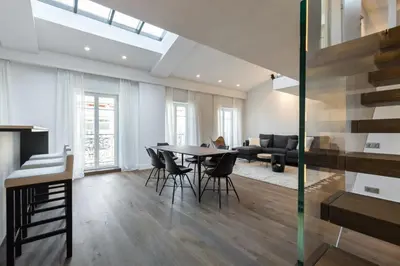a living room with a table and chairs and a couch at Duplex Nice Avenue Jean-Médecin in Nice