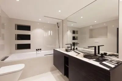 a bathroom with a sink and a toilet and a tub at Duplex Nice Avenue Jean-Médecin in Nice