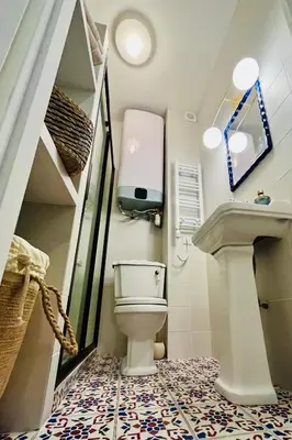 a bathroom with a toilet and a sink at CHEZ TAMARA in Nice