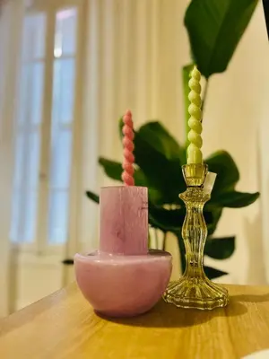 a table with a pink candle and a gold vase at CHEZ TAMARA in Nice