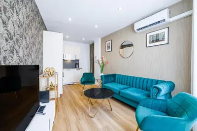 a living room with a blue couch and a table at Nice Renting - OFFENBACH - Luxury Apartment Fully Equipped Center in Nice