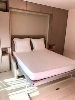 a bed in a small room with white sheets and pillows at Studios Nice Gambetta in Nice