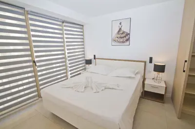 a white bed with white sheets and pillows in a bedroom at Sea Front Palace Promenade in Nice