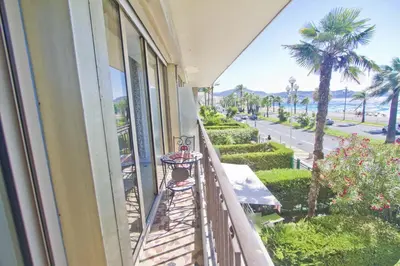 a balcony of a building with a view of the ocean at Sea Front Palace Promenade in Nice
