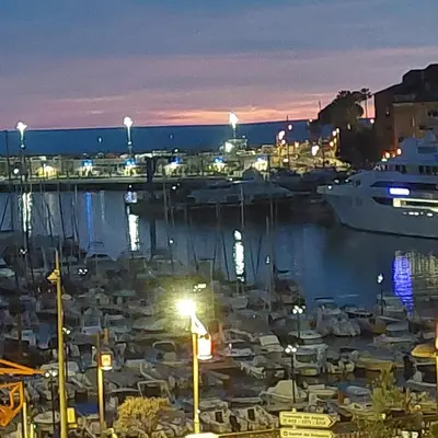 a group of boats docked in a marina at night at MAO in Nice