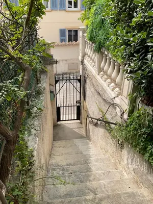 an alley with a gate in a building at Douceur d'Azur in Nice