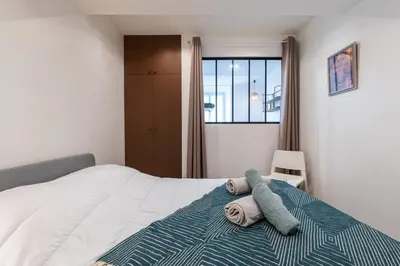 a bedroom with a bed with two towels on it at MY CASA - MARI 71 - Unique Apt Near Sea in Nice