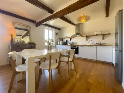 a kitchen and dining room with a white table and chairs at Saint Francois de Paul - wifi, AC, 6 pers in Nice