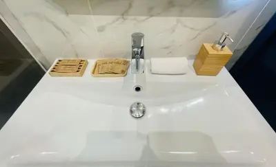 a white bathroom sink with a faucet and towels at Old Town Nice Place Rossetti Themed 2BR Apartment Full Air Conditioning in Nice
