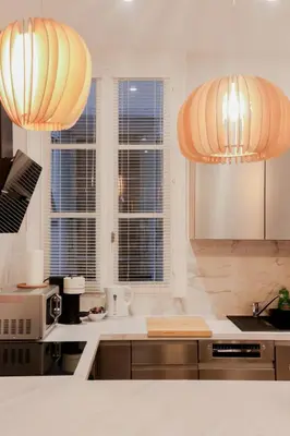 a kitchen with two chandeliers above a kitchen counter at Old Town Nice Place Rossetti Themed 2BR Apartment Full Air Conditioning in Nice