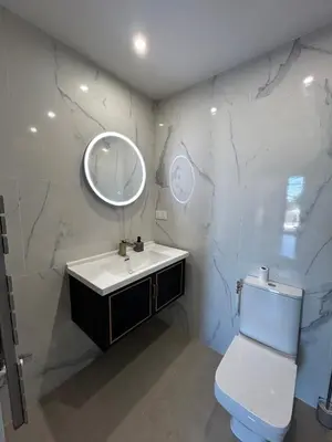 a bathroom with a toilet and a sink and a mirror at Èze - Appartement dans bas de villa avec piscine près de Monaco in Èze