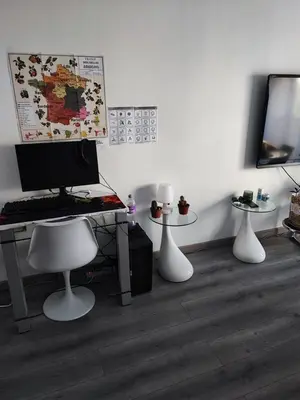 a room with a desk with a computer and three tables at Studio 31 m² in Nice