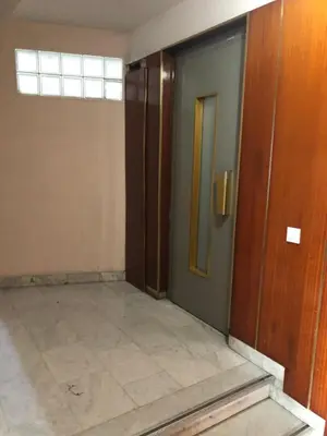 an empty hallway with a door and a tile floor at Promenade des anglais 20 mètres in Nice