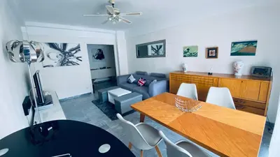 a living room with a table and a couch at Confortable et Spacieux 3pièces, très bien situé in Nice