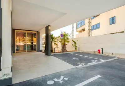 an empty parking lot in front of a building at B&B HOTEL Nice Stade Riviera in Nice