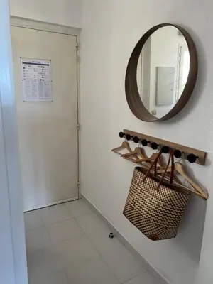a bathroom with a mirror and a white tile floor at Pool , 150m to beach, seaview in Villefranche-sur-Mer