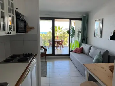 a kitchen and living room with a couch and a table at Pool , 150m to beach, seaview in Villefranche-sur-Mer