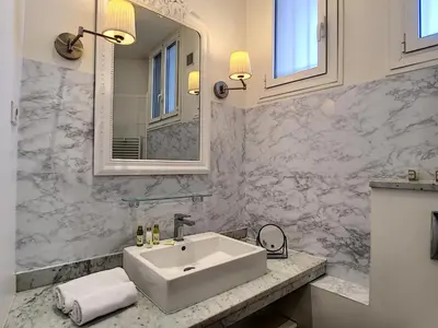 a bathroom with a white sink and a mirror at Nestor&Jeeves - PALAZZO VERDI - Central in Nice