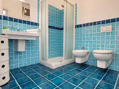a blue tiled bathroom with a toilet and a shower at Nestor&Jeeves - BEACH ROYAL - Central, Close sea in Nice