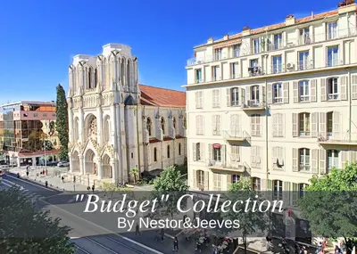 a building with a clock tower next to a street at Nestor&Jeeves - DOLCE VITA MASTER - Jean Medecin in Nice