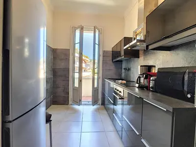 a kitchen with a stainless steel refrigerator and appliances at Nestor&Jeeves - CHILL LOUNGE - City center, close sea in Nice