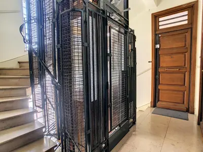 a hallway with a staircase with a gate and a door at Nestor&Jeeves - CHILL LOUNGE - City center, close sea in Nice