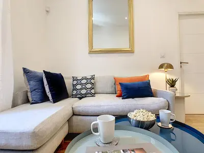 a living room with a couch and a glass table at Nestor&Jeeves - COZY MACCARANI - City Center, Close sea in Nice
