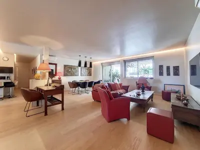 a living room with a couch and a table at Nestor&Jeeves - FLEURS TERRASSE - 3 chambres in Nice
