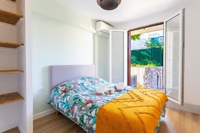 a bedroom with a bed and a window at LE MONT ALBAN AP4360 By Riviera Holiday Homes in Villefranche-sur-Mer