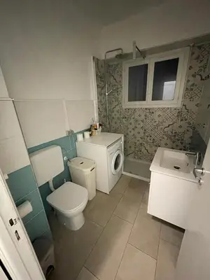 a small bathroom with a toilet and a sink at Gloria apartments in Nice
