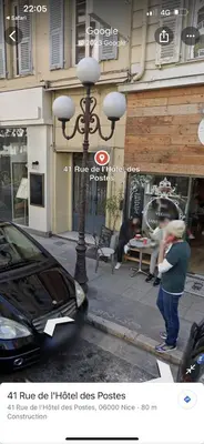 a woman standing on a street corner near a car at AMAZING STUDIO - GRANDE TERRASSE - COEUR DE VILLE - WIFI - AC in Nice