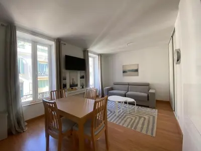 a living room with a table and a couch at PACA01 in Nice