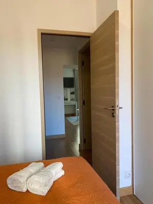 a bedroom with a bed with two white towels on it at PACA01 in Nice
