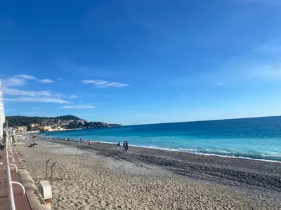 a group of people walking on the beach at Heart of Nice-Rooftop Seaside Studio in Nice