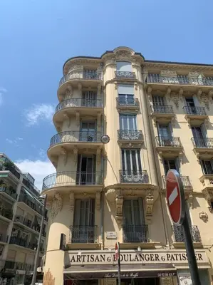 a tall building with a sign in front of it at Heart of Nice-Rooftop Seaside Studio in Nice