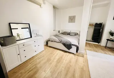 a bedroom with a bed and a dresser and a mirror at Sublime Appartement 2 pièces au cœur de la Vieille Ville in Nice