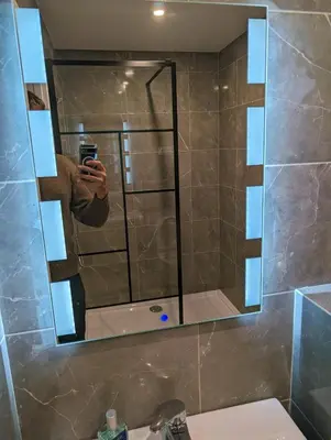 a person taking a picture of a mirror in a bathroom at Holiday Nice Studio in Nice