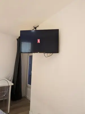 a television on top of a wall in a room at Holiday Nice Studio in Nice