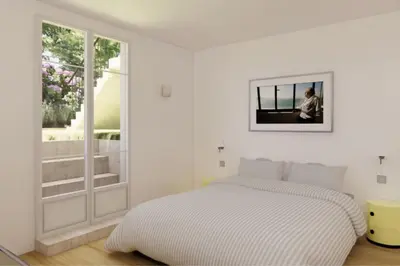 a white bedroom with a bed and a window at Luxury flat for 6 in center of Nice By ask me france in Nice