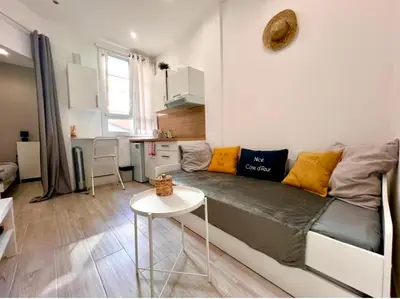 a living room with a couch and a table at Congrès Résidence in Nice