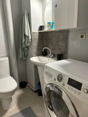 a bathroom with a washing machine and a sink at Studio lumineux avec balcon à proximité de la mer in Nice
