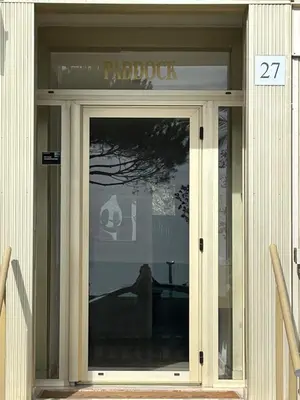 a glass door of a building with a sign on it at Riviera 1 ou Riviera 2 ou réservez les 2 Front de Mer Cagnes sur Mer Promenade de la plage in Cagnes-sur-Mer