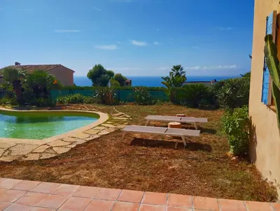 a picnic bench sitting next to a swimming pool at L'Albizia in Nice