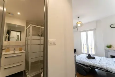 a small bedroom with a bed and a mirror at Nice Centre STUDIO avec BALCON in Nice
