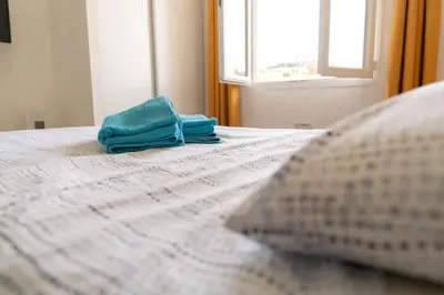a bed with two towels sitting on top of it at NICE Centre-ville Studio en étage refait à neuf in Nice