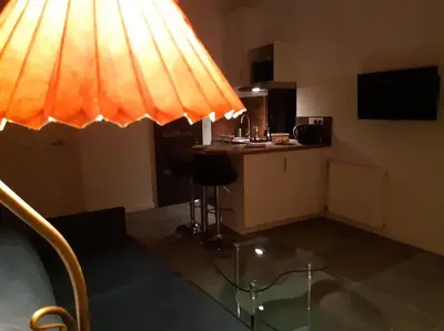 a room with a table with a lamp on top of it at NICE Centre-ville Studio en étage refait à neuf in Nice