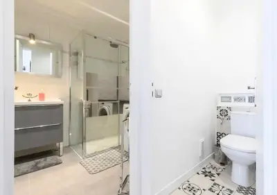a white bedroom with a bed and some furniture at Beautiful & spacious 2 bed Apt near Nice Center in Nice